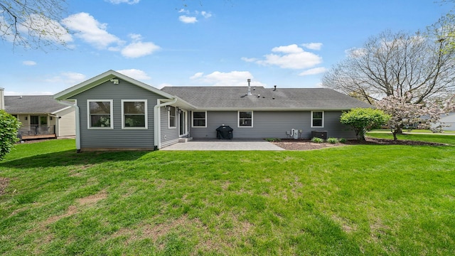 back of house featuring a lawn, central air condition unit, and a patio