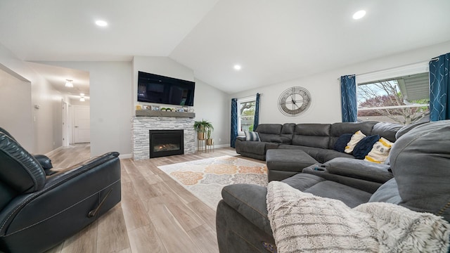 living area featuring vaulted ceiling, recessed lighting, plenty of natural light, and light wood-style floors