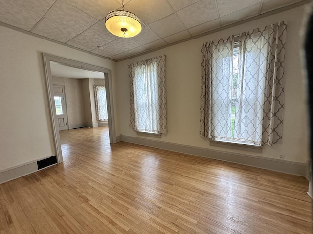 503 N William St, Farmer City, IL 61842 - empty room featuring light wood-type flooring, baseboards, visible vents, and a paneled ceiling
