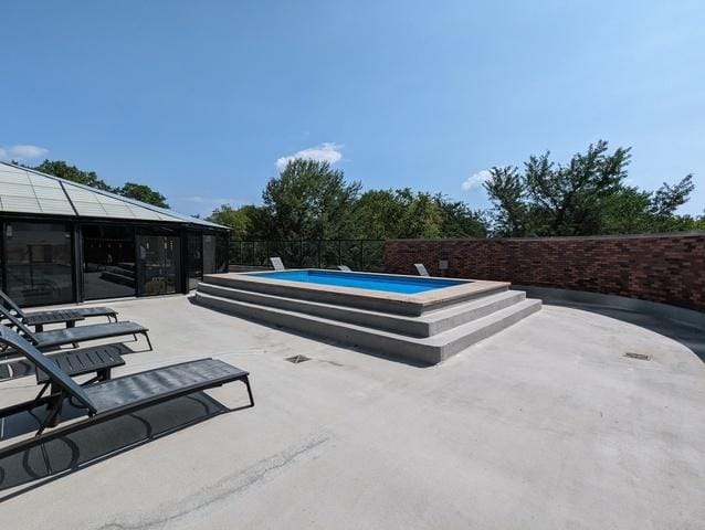 view of patio / terrace featuring fence and a fenced in pool