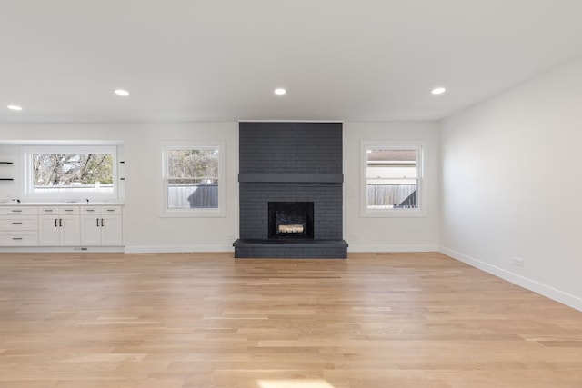 617 Sara Ln, Naperville, IL 60565 - unfurnished living room with a brick fireplace, recessed lighting, baseboards, and light wood-type flooring