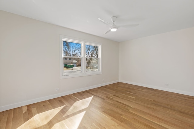 617 Sara Ln, Naperville, IL 60565 - empty room with a ceiling fan, baseboards, and light wood-style flooring