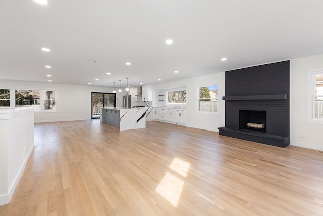 617 Sara Ln, Naperville, IL 60565 - unfurnished living room featuring light wood-style floors, recessed lighting, and a wealth of natural light