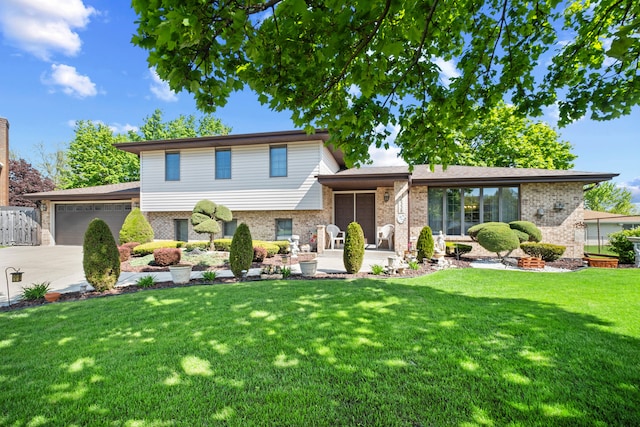 6338 Parkwood Ct, Oak Forest, IL 60452 - split level home with an attached garage, brick siding, driveway, and a front yard