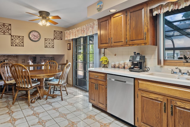 6338 Parkwood Ct, Oak Forest, IL 60452 - kitchen featuring stainless steel dishwasher, brown cabinets, light countertops, a sink, and backsplash