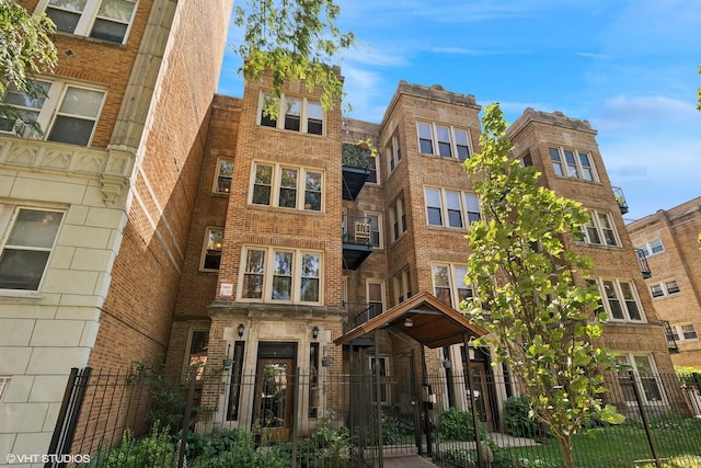 view of building exterior with a fenced front yard