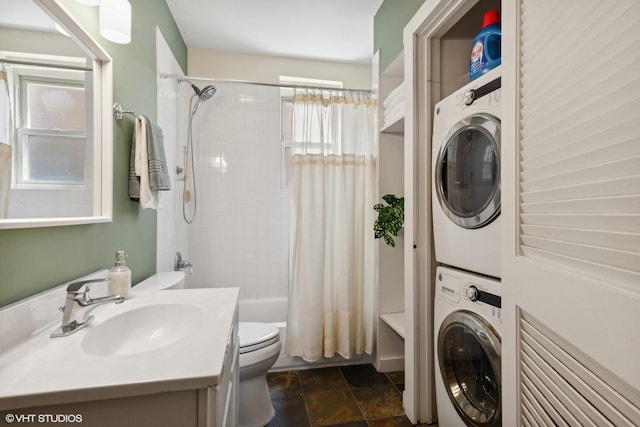 full bath featuring stacked washer / dryer, toilet, a healthy amount of sunlight, and shower / bath combination with curtain