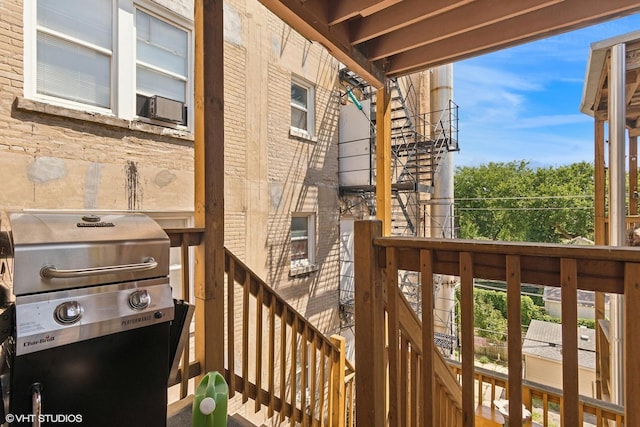 deck featuring cooling unit, grilling area, and stairs