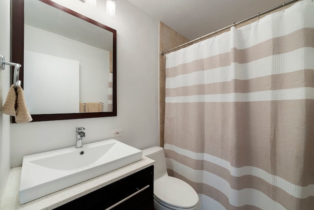 full bathroom with vanity, toilet, and curtained shower