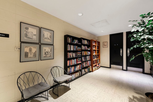 sitting room with recessed lighting and carpet