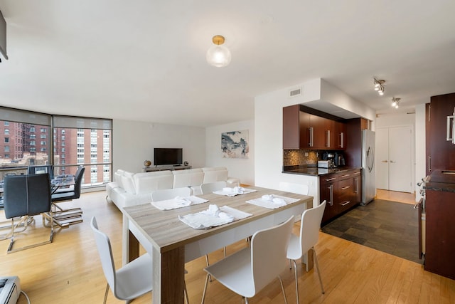 dining room with wood finished floors and visible vents