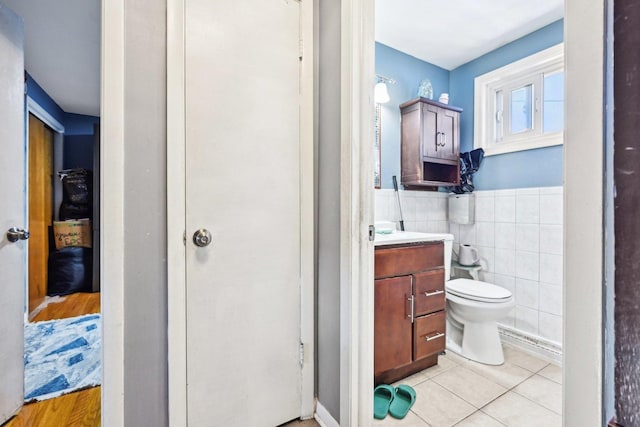 7303 N Campbell Ave Unit A, Chicago, IL 60645 - bathroom with tile patterned flooring, tile walls, vanity, and toilet