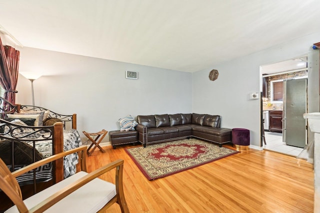 7303 N Campbell Ave Unit A, Chicago, IL 60645 - living area featuring light wood finished floors and baseboards