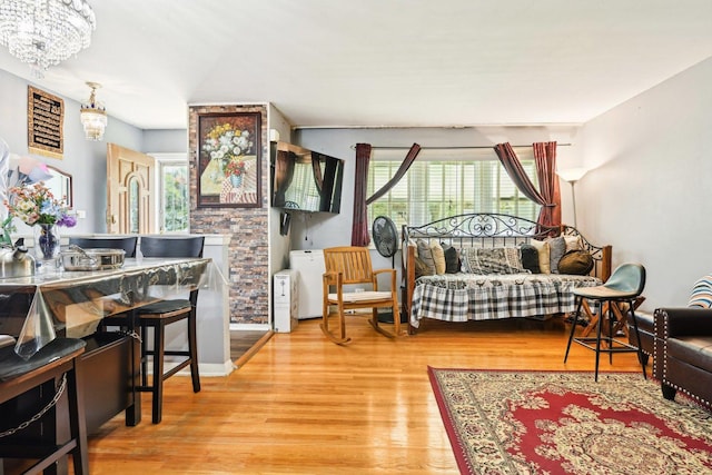 7303 N Campbell Ave Unit A, Chicago, IL 60645 - living room featuring a chandelier and wood finished floors