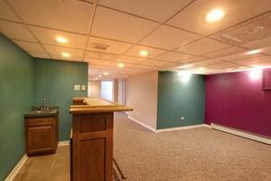 6511 174th St, Tinley Park, IL 60477 - bar area with recessed lighting, a baseboard radiator, baseboards, a paneled ceiling, and light colored carpet