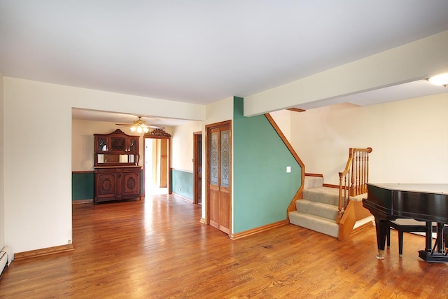 6511 174th St, Tinley Park, IL 60477 - living area featuring a baseboard radiator, wood finished floors, stairs, ceiling fan, and baseboards
