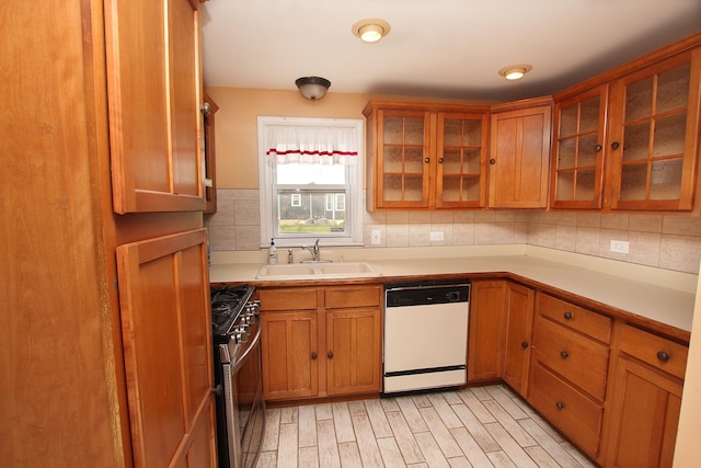 6511 174th St, Tinley Park, IL 60477 - kitchen featuring white dishwasher, a sink, gas stove, light countertops, and brown cabinetry