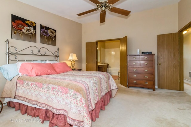 carpeted bedroom featuring ensuite bathroom and ceiling fan