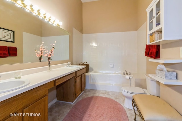 bathroom with a garden tub, toilet, double vanity, and tile patterned flooring