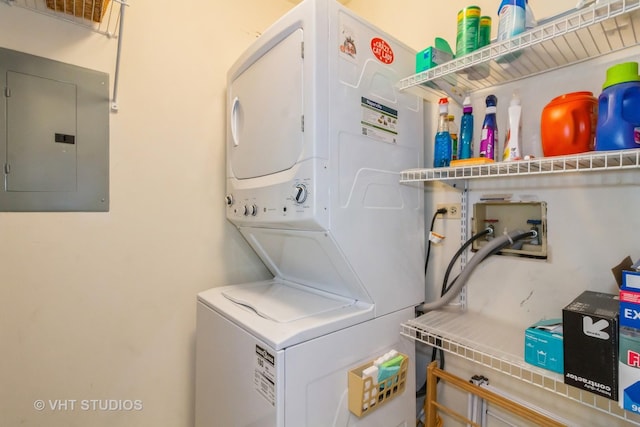 laundry room with stacked washer and clothes dryer and electric panel
