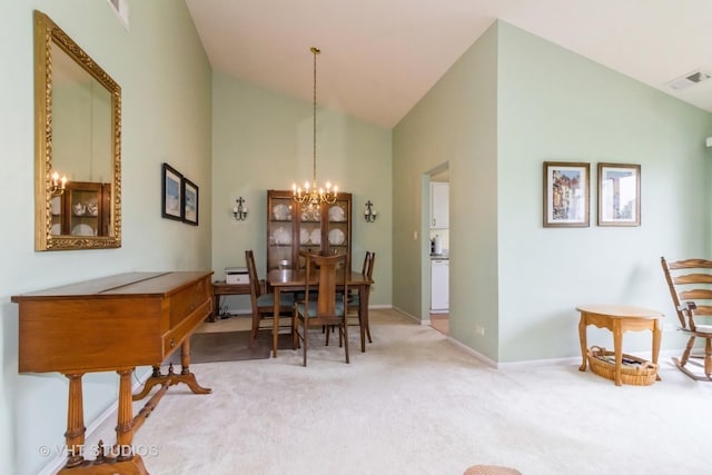 dining area featuring a chandelier, high vaulted ceiling, carpet, and baseboards