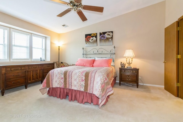 bedroom with light colored carpet, a ceiling fan, baseboards, and lofted ceiling