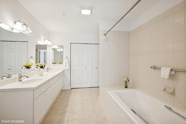 44 N Vail Ave Unit 313, Arlington Heights, IL 60005 - bathroom with a closet, tile patterned flooring, a relaxing tiled tub, and double vanity