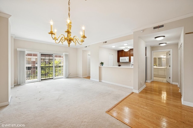 44 N Vail Ave Unit 313, Arlington Heights, IL 60005 - unfurnished living room featuring a chandelier, ornamental molding, baseboards, and light wood-type flooring