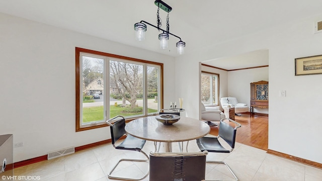 dining room with light tile patterned floors, baseboards, and visible vents