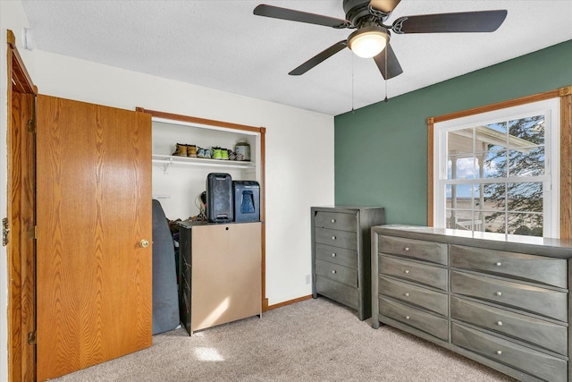 bedroom featuring a closet, ceiling fan, and light carpet