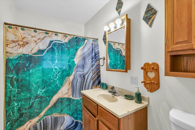 bathroom featuring vanity and toilet