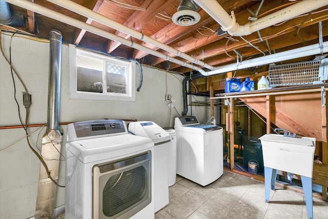 washroom featuring laundry area, washing machine and dryer, and visible vents