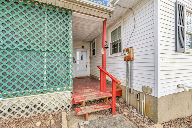 entrance to property with an attached carport