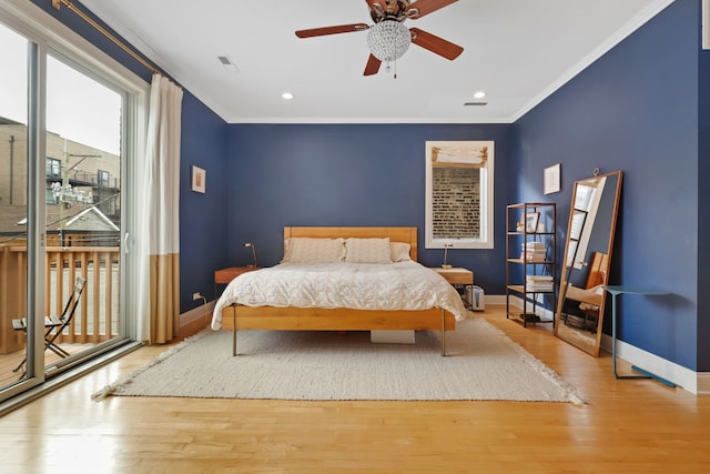bedroom featuring multiple windows, crown molding, baseboards, access to outside, and wood finished floors