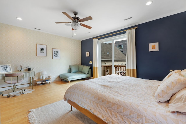 bedroom with wood finished floors, access to outside, ornamental molding, recessed lighting, and wallpapered walls