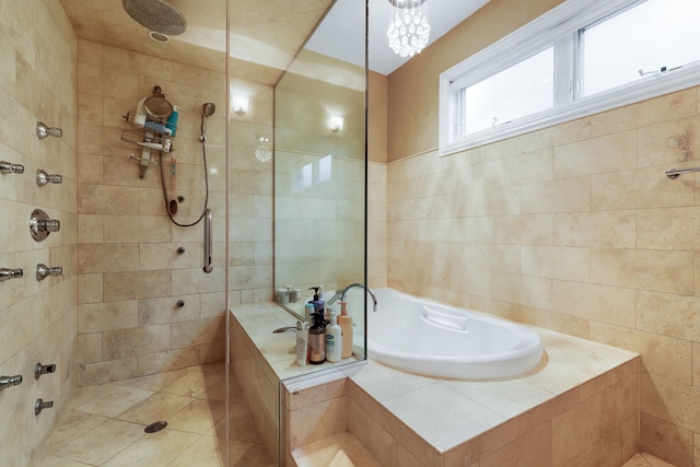bathroom with a tile shower, a bath, and tile patterned floors
