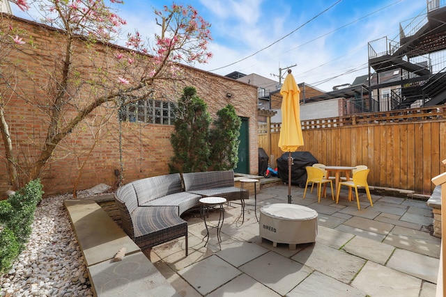 view of patio featuring an outdoor living space, a fenced backyard, grilling area, and outdoor dining area