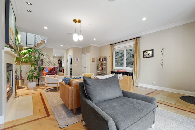 living area with stairs, recessed lighting, ornamental molding, baseboards, and a glass covered fireplace