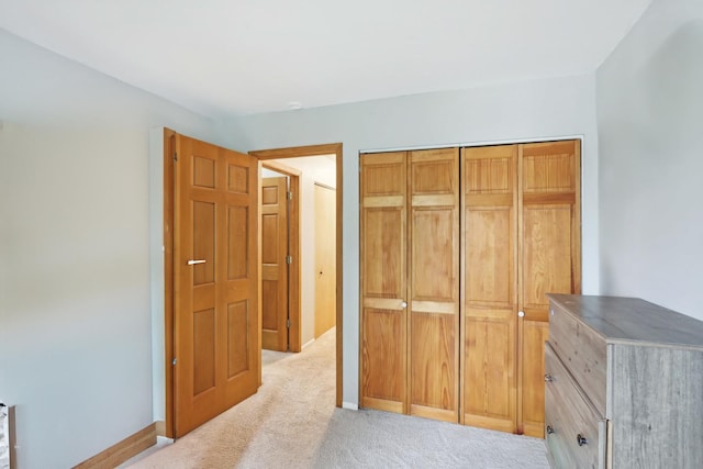 810 E Kings Row Unit 6, Palatine, IL 60074 - unfurnished bedroom featuring a closet, baseboards, and light carpet