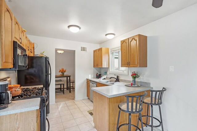 810 E Kings Row Unit 6, Palatine, IL 60074 - kitchen with a breakfast bar area, visible vents, black microwave, a sink, and range with gas stovetop