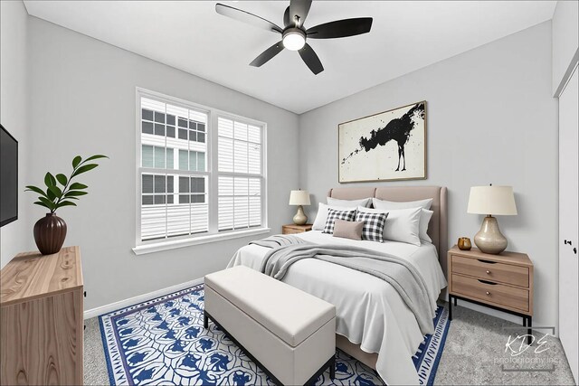 carpeted bedroom with a ceiling fan and baseboards
