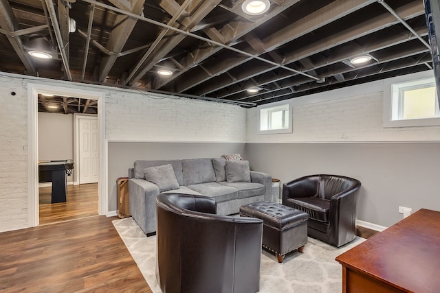220 N Myrtle Ave, Elmhurst, IL 60126 - living room featuring brick wall, baseboards, and wood finished floors
