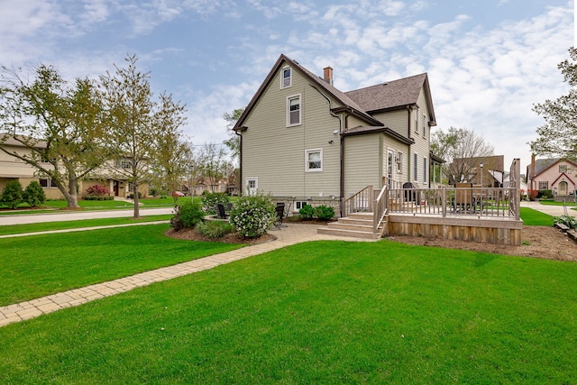 220 N Myrtle Ave, Elmhurst, IL 60126 - back of property with a lawn, a wooden deck, a chimney, and roof with shingles