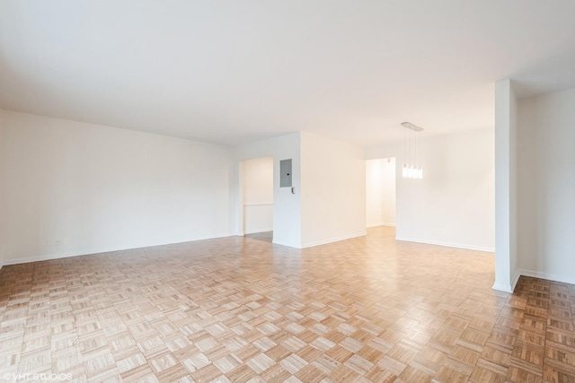 2400 W Archbury Ln Unit 3E, Park Ridge, IL 60068 - spare room featuring baseboards, electric panel, and a chandelier