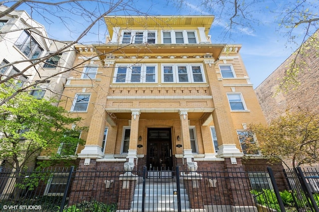 5615 N Wayne Ave Unit 3S, Chicago, IL 60660 - multi unit property featuring brick siding, a fenced front yard, and a gate