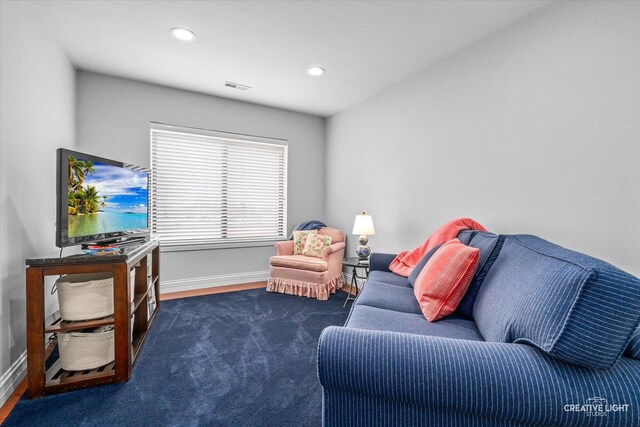 carpeted living room featuring baseboards, recessed lighting, and visible vents