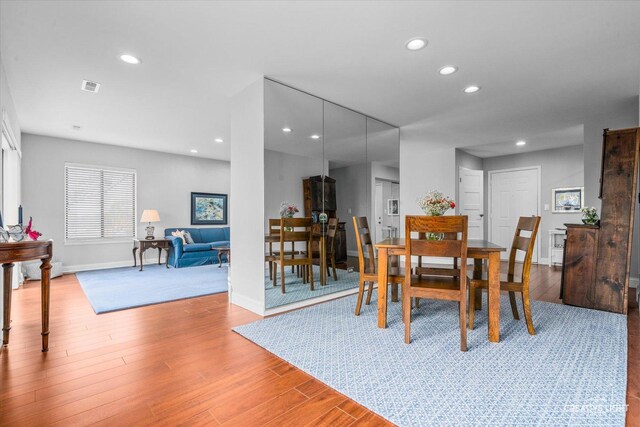 dining area featuring baseboards, light wood-type flooring, recessed lighting, and visible vents