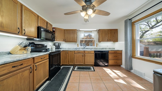 1008 Mary Ave, Dixon, IL 61021 - kitchen with black appliances, a sink, brown cabinetry, and a ceiling fan