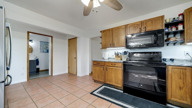 1008 Mary Ave, Dixon, IL 61021 - kitchen with black appliances, light tile patterned floors, ceiling fan, and brown cabinetry