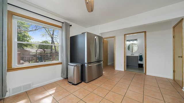 1008 Mary Ave, Dixon, IL 61021 - kitchen with freestanding refrigerator, light tile patterned floors, and baseboards